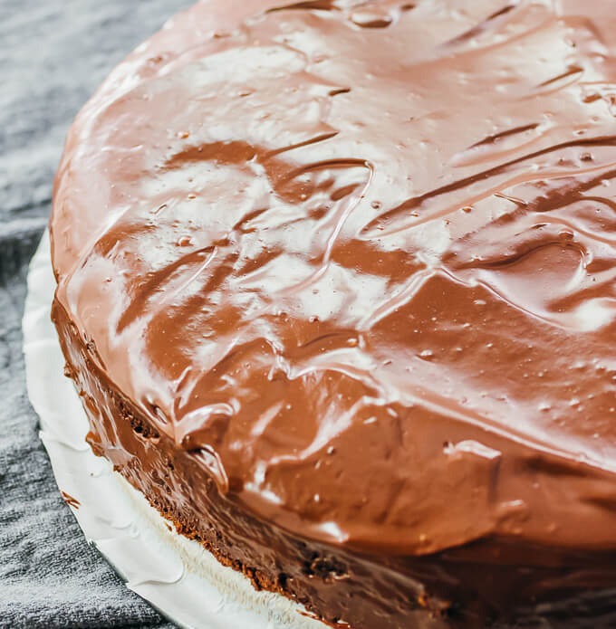 ganache spread over chocolate cake