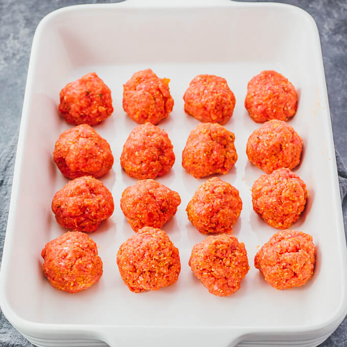 raw meatballs in baking dish