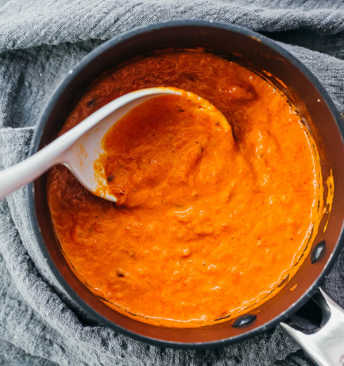 stirring creamy marinara sauce in pot