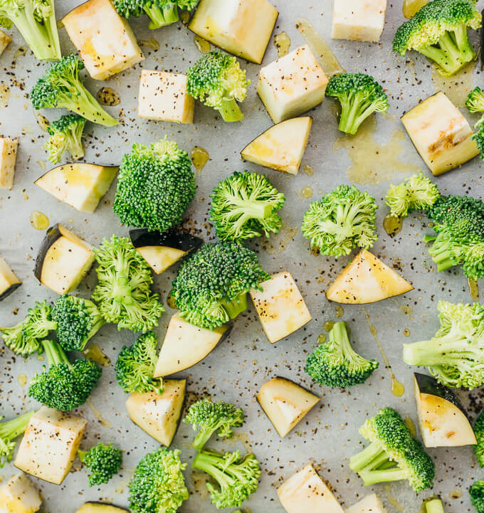 raw eggplant and broccoli on parchment paper