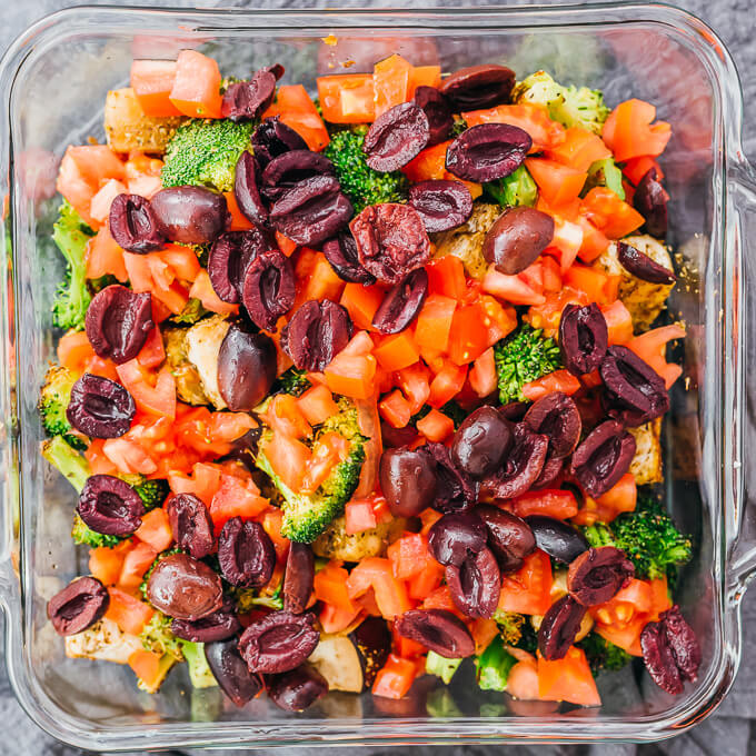 adding olives and tomatoes to casserole dish