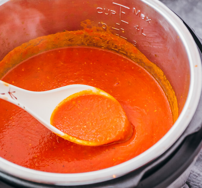 ladling up tomato soup from instant pot
