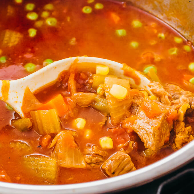 ladling vegetable beef soup