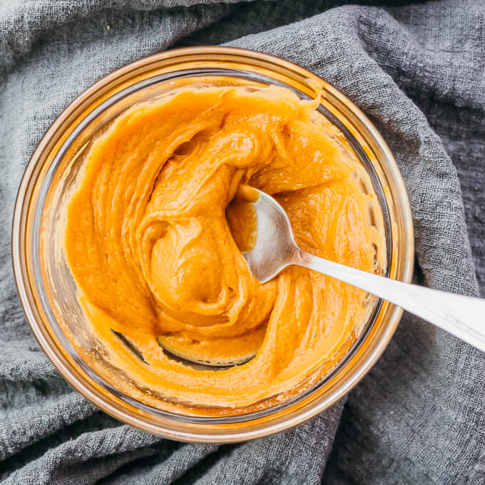 stirring peanut sauce in glass prep bowl