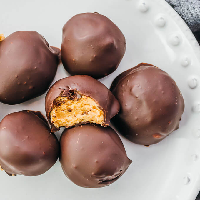 keto chocolate peanut butter balls on a white plate