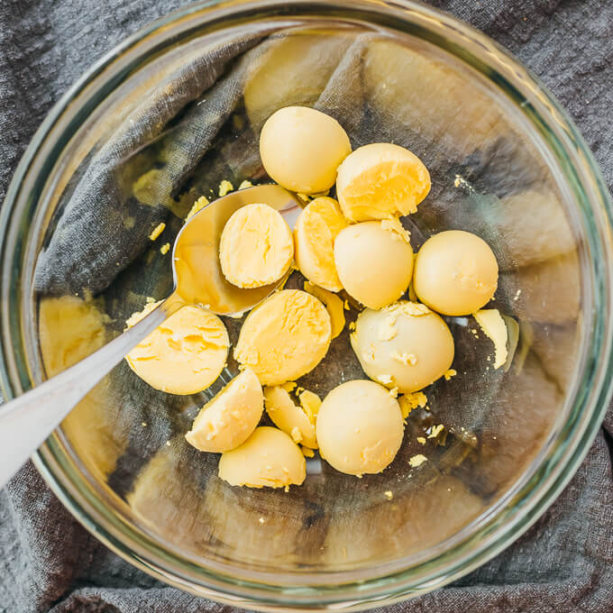 cooked egg yolks in glass bowl