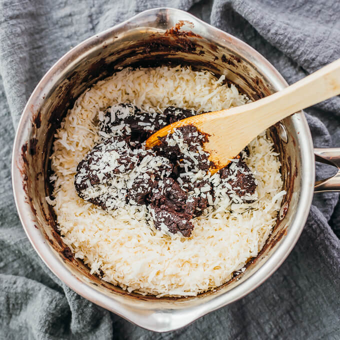 stirring coconut flakes into chocolate cookie dough