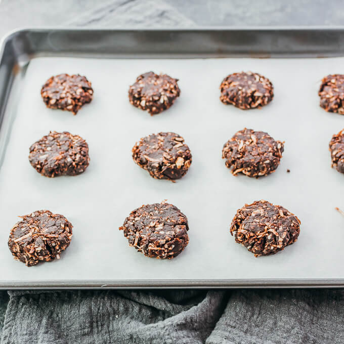 flattened cookies on parchment paper