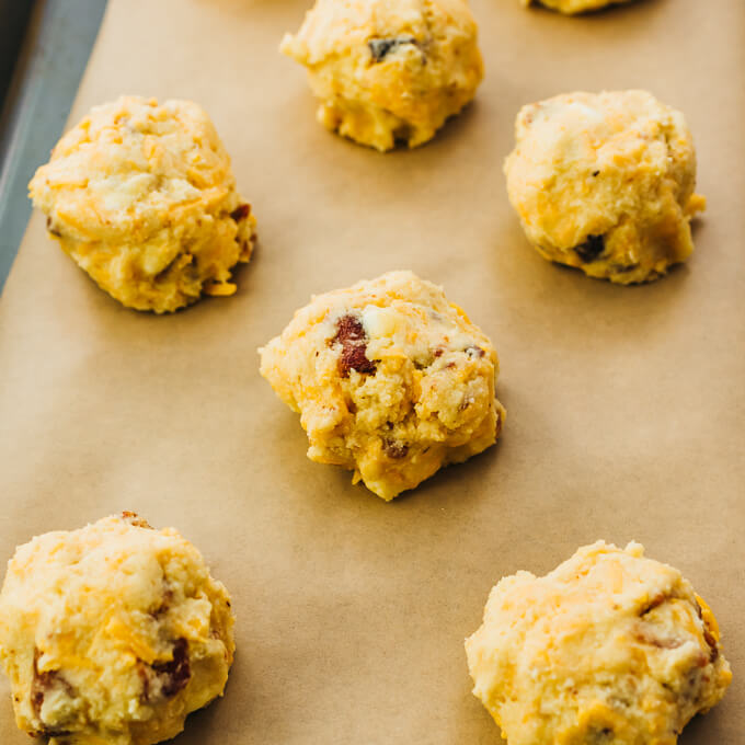 biscuit dough formed into balls on parchment paper