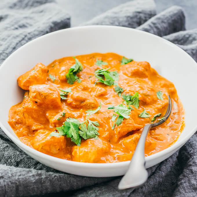 butter chicken served in white bowl