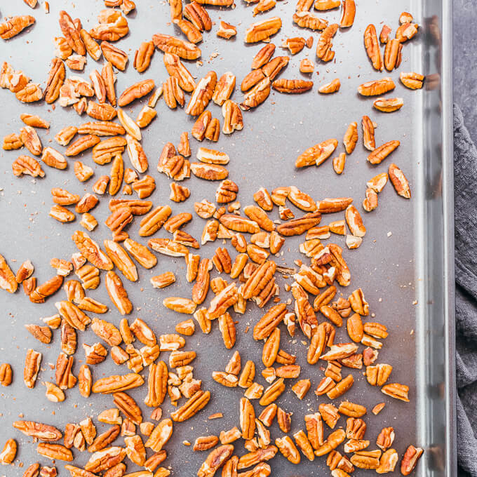 pecan pieces toasted on a baking sheet