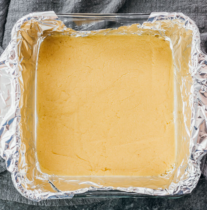 a smooth almond flour crust in a baking dish