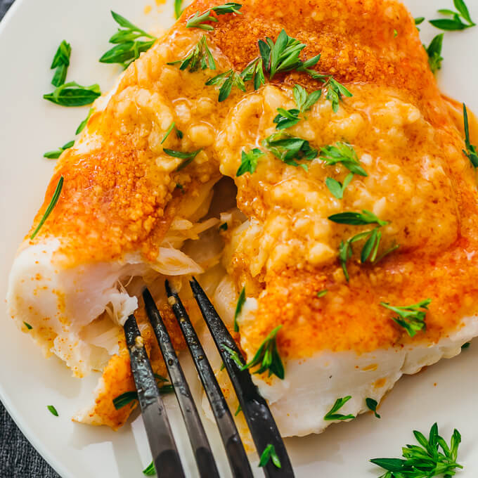 flaking a baked cod fillet with a fork