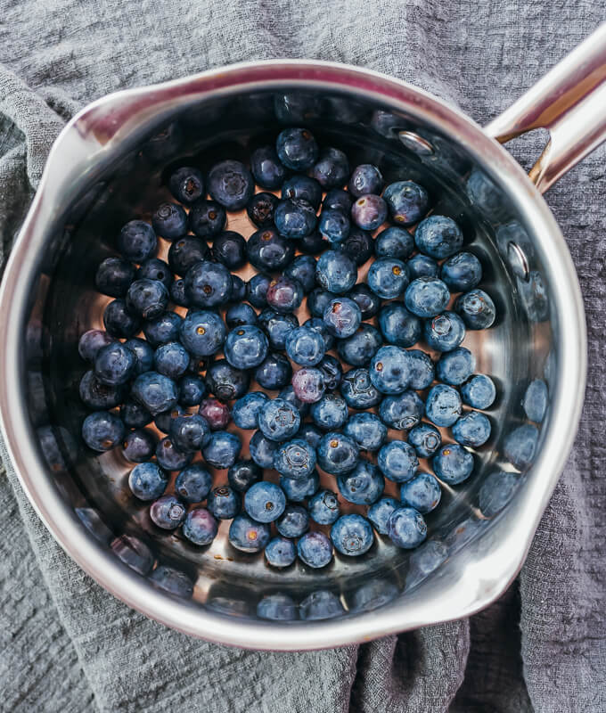 fresh blueberries added to a saucepan