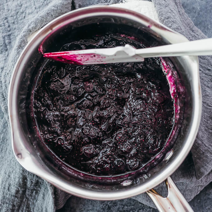 stirring blueberry jam in saucepan