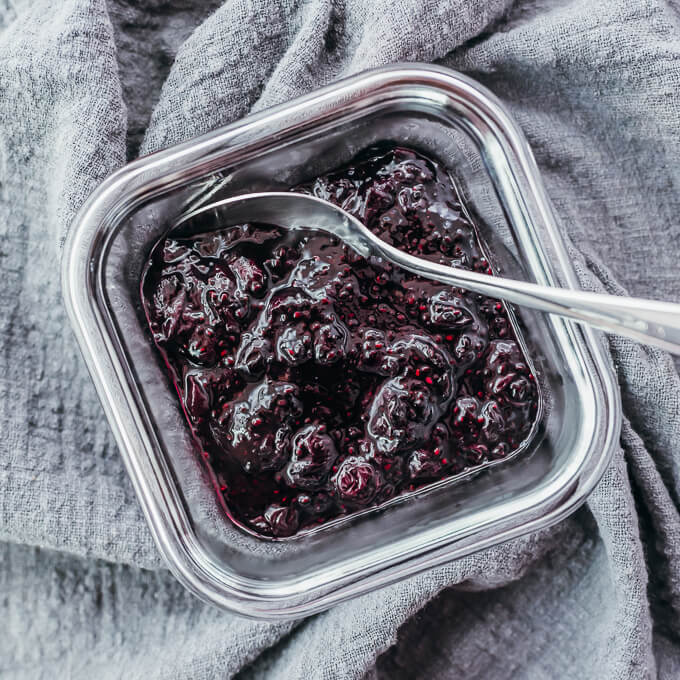 overhead view of blueberry jam in a glass container