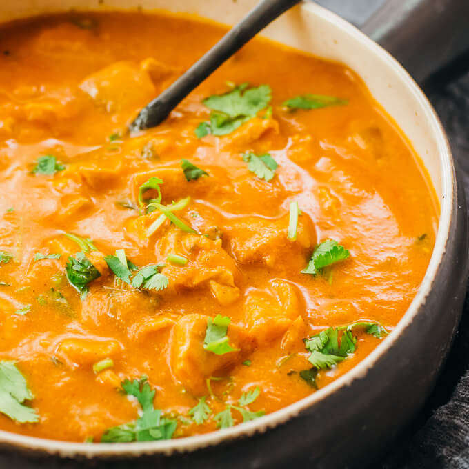 closeup view of tender chicken chunks in orange sauce