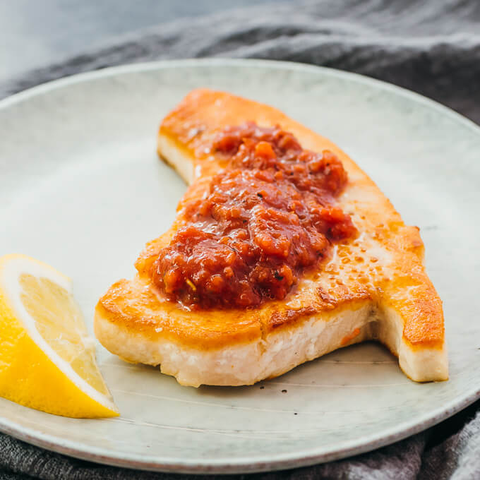 close up view of cooked swordfish with salsa