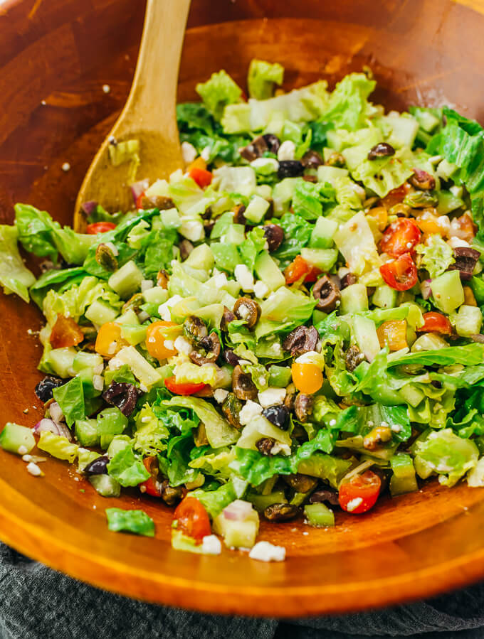 tossing together salad ingredients