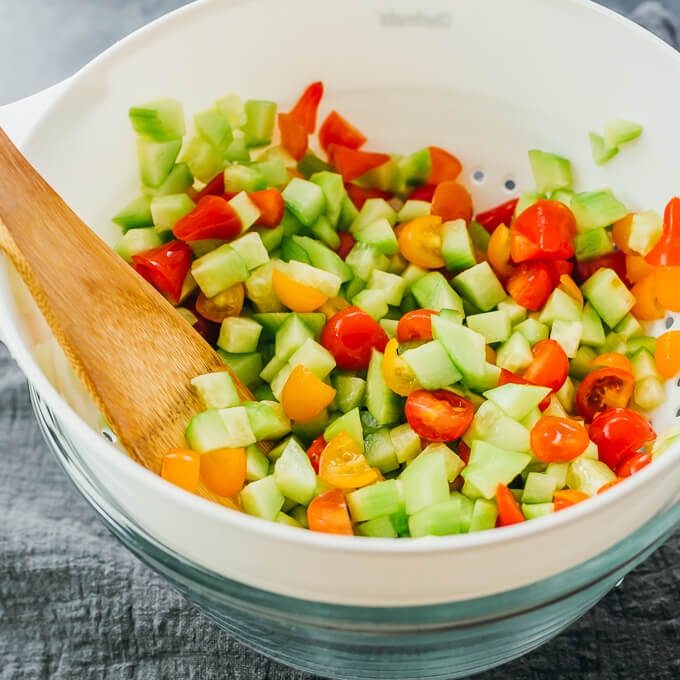 salting cucumbers and tomatoes in colander