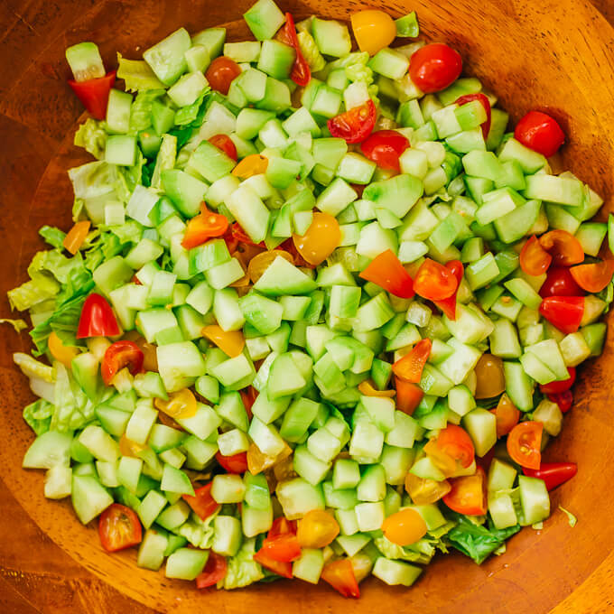 cucumbers and tomatoes in wooden bowl