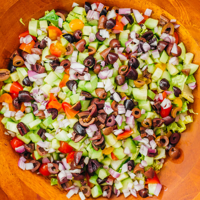 olives and shallots in wooden bowl