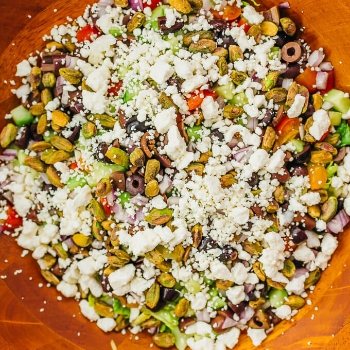 feta and pistachios in wooden bowl