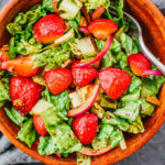 overhead view of strawberry salad in wooden bowl