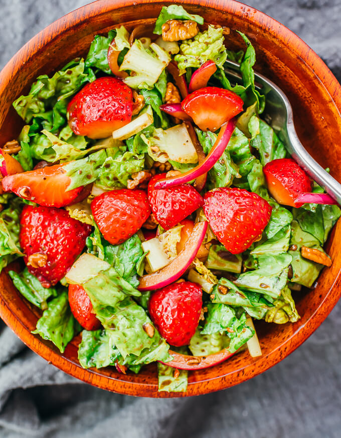 overhead view of strawberry salad in wooden bowl