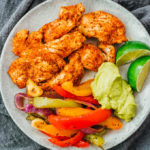 chicken fajitas served on plate with guacamole