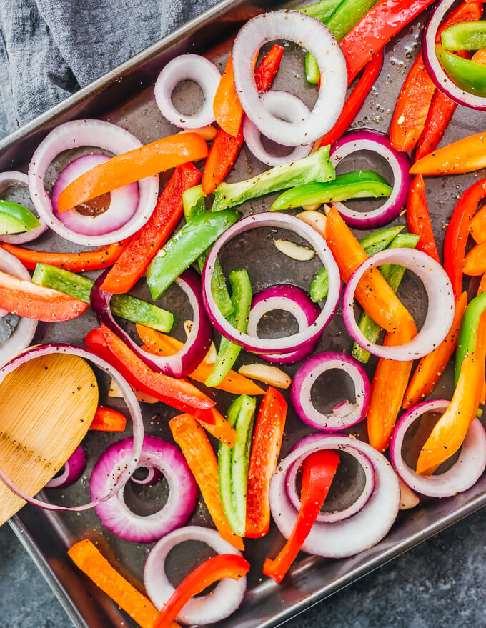 mixing bell peppers and onions with seasonings