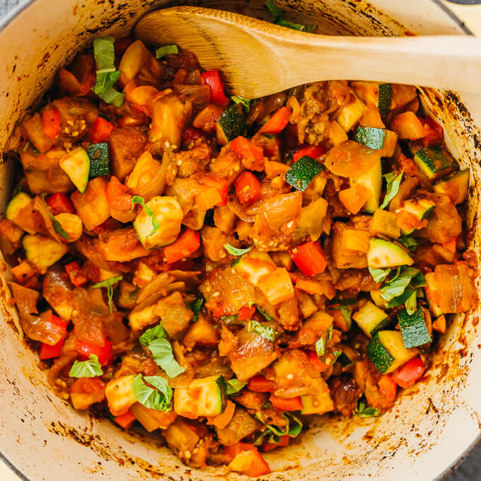 stirring ratatouille in a dutch oven