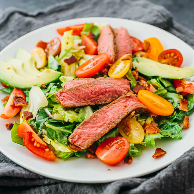 steak salad served on white plate