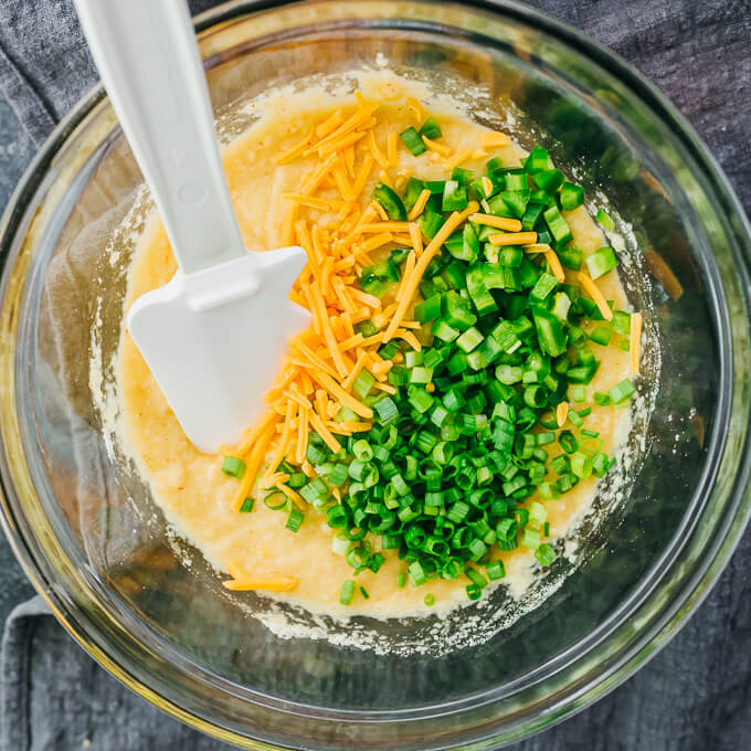 stirring cornbread batter in bowl