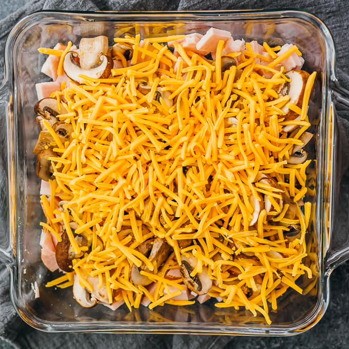 shredded cheddar cheese in baking dish