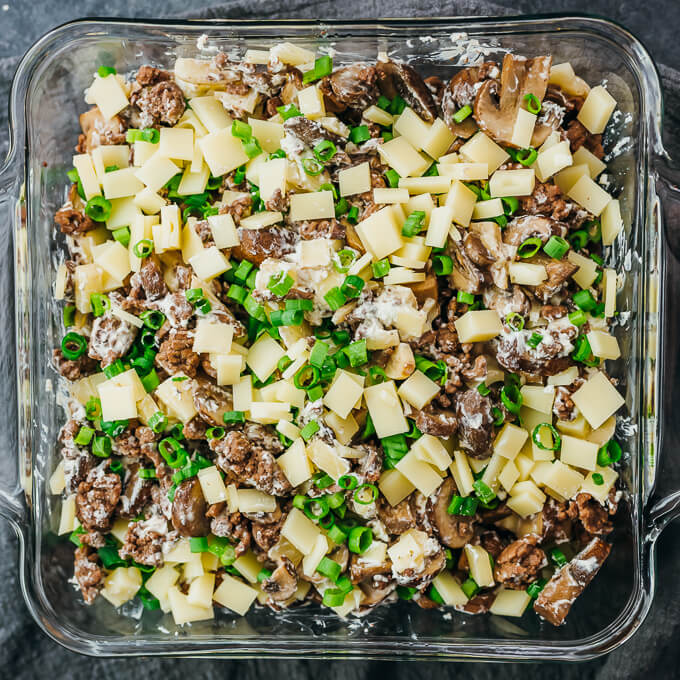 cheese and scallions added to casserole dish