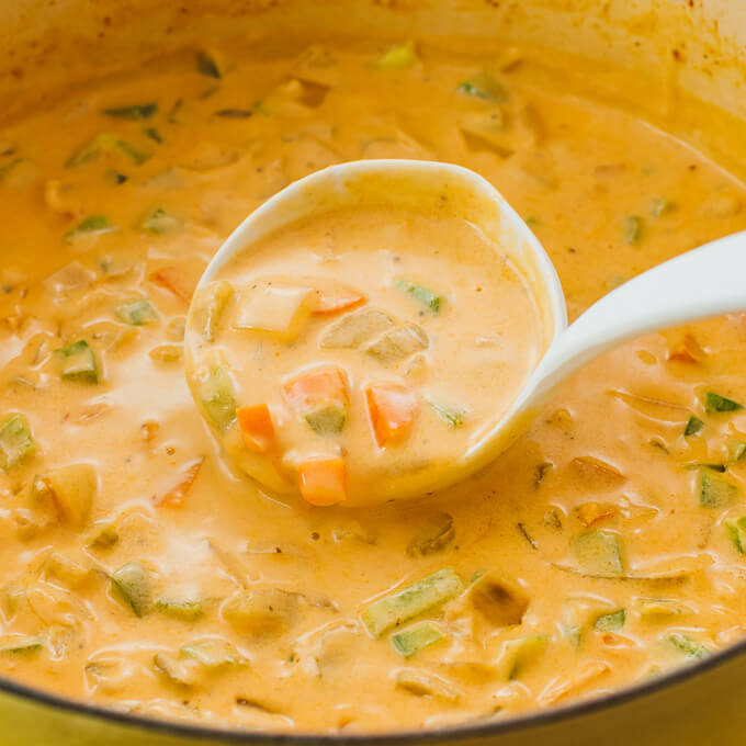 using a ladle to serve vegetable soup