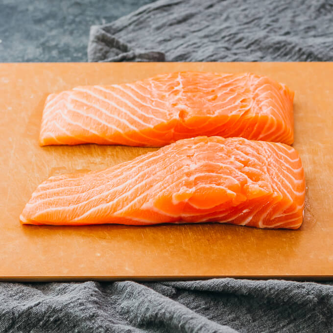 raw fresh salmon fillets on a cutting board