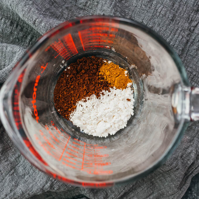 coffee powder, cinnamon, and sweetener in measuring glass