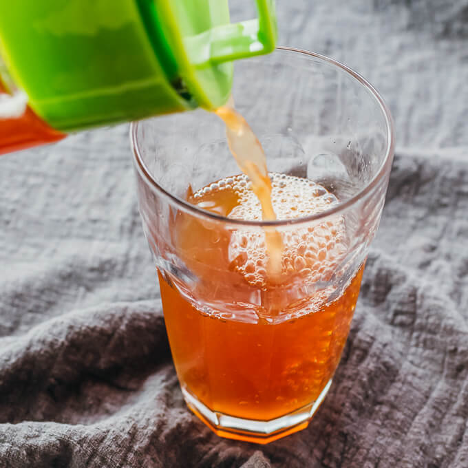 pouring iced tea into a glass