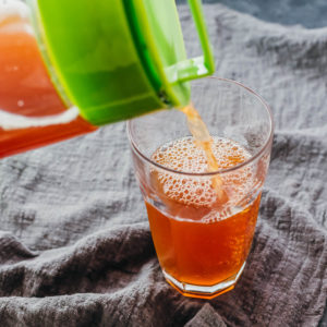 pouring iced tea into a glass