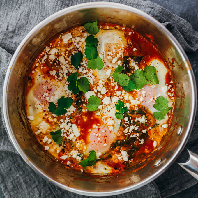 cooking low carb spinach shakshuka in pan