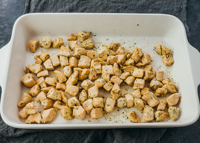 cooked chicken cubes in baking dish