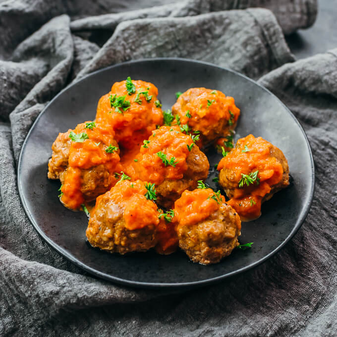 parsley sprinkled on meatballs with sauce