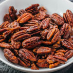 candied pecans in white bowl