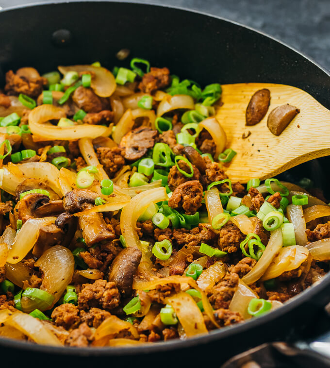 stirring ground beef stir fry in pan