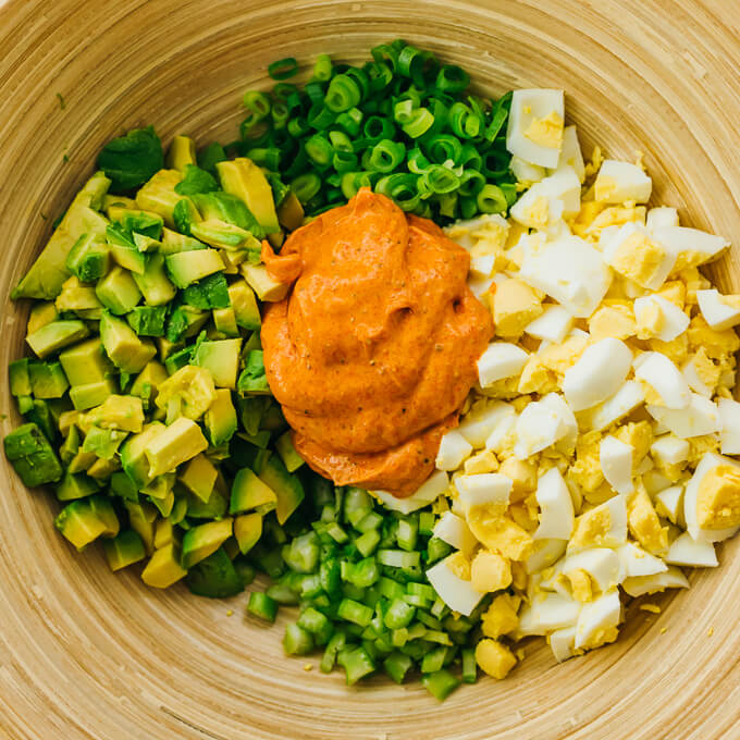 all egg salad ingredients in wooden salad bowl