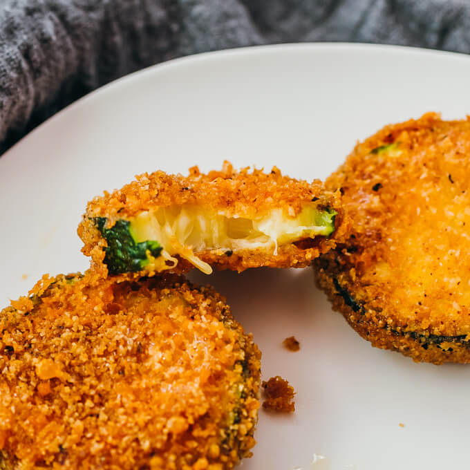 half eaten fried zucchini slice on plate