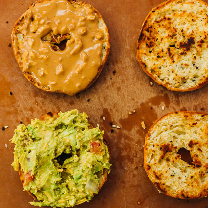 keto bagels spread with guacamole and peanut butter