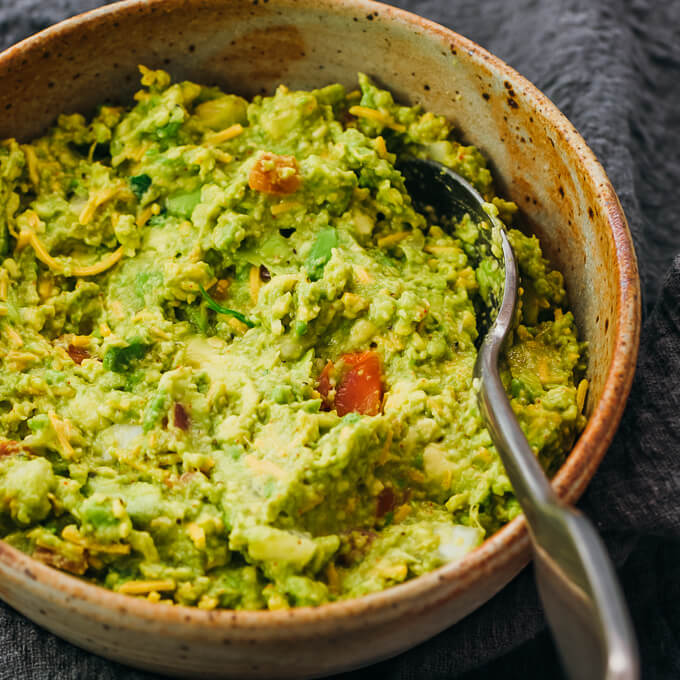 close up view of guacamole served in stoneware bowl